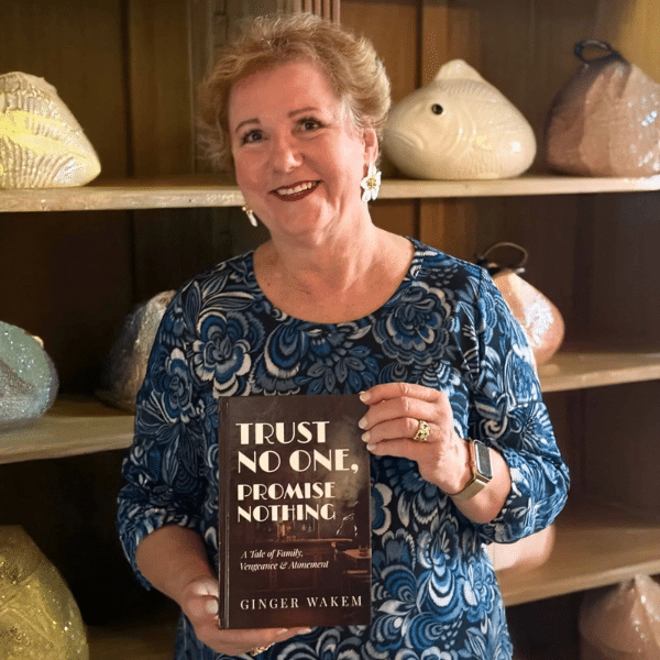 Ginger with her book in front of a fish