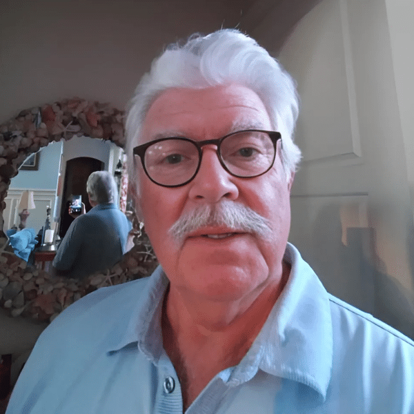 guy in blue shirt with silver hair